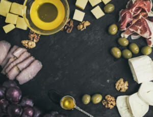 Wine appetizer set: cheese and meat selection with grapes, honey